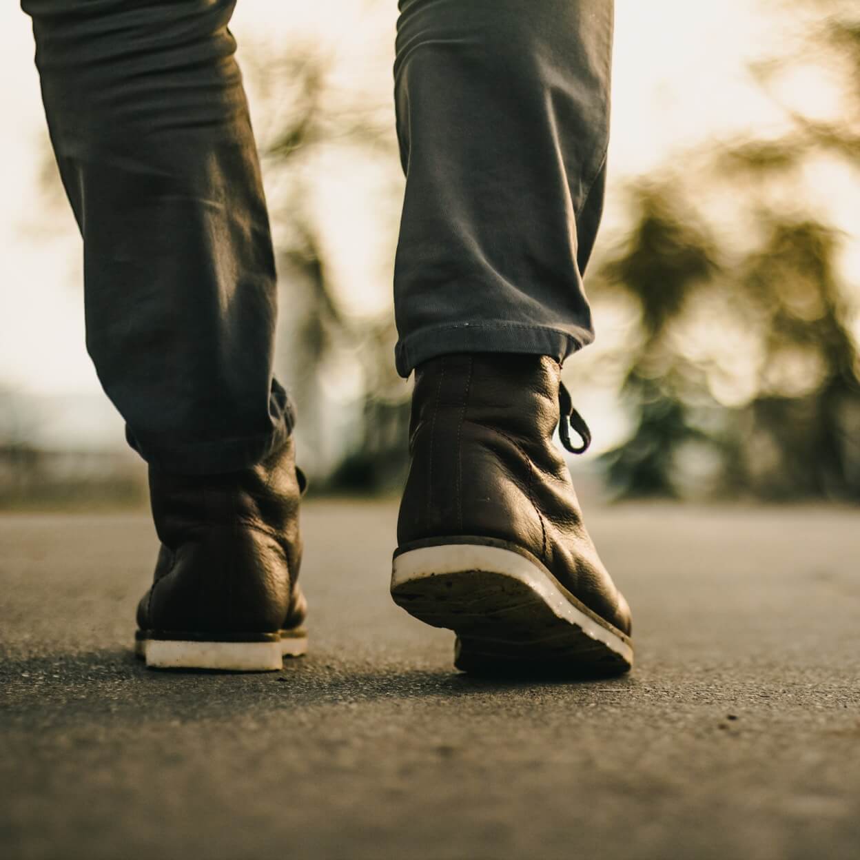 Close-up of boots walking away from camera